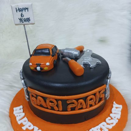 Auto parts theme cake in Karachi with miniature car and tools for car lovers