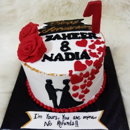 Personalized 1st Anniversary Cake with red roses, hearts, and custom names in Karachi.