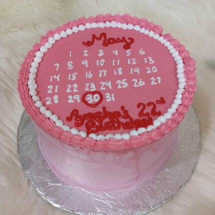 Pink calendar theme birthday cake with highlighted date.