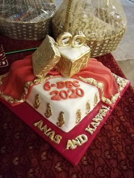 Golden Rings & Dupatta Delight Engagement Cake with golden rings and traditional dupatta design in Karachi.