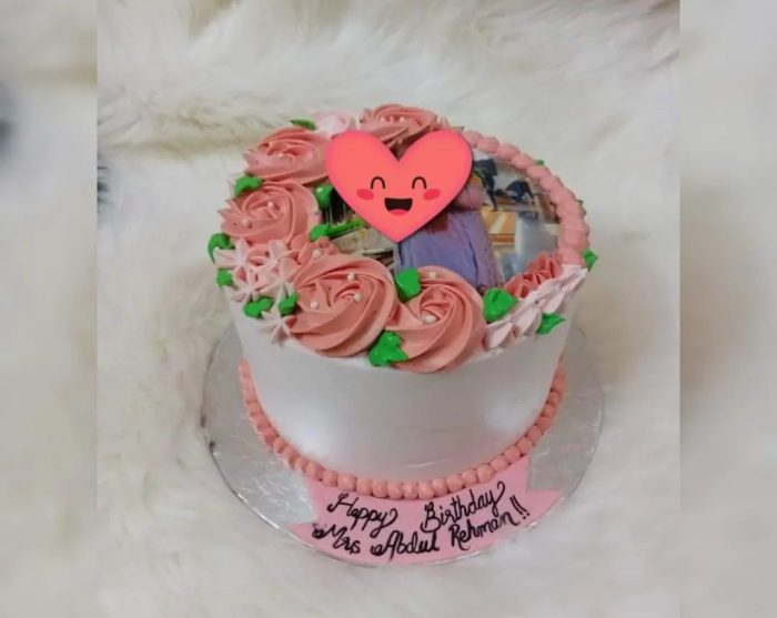 Picture-Perfect Cake in Karachi with a personalized photo and floral decorations.