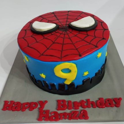 Spiderman-themed 9th birthday cake with city skyline design in Karachi