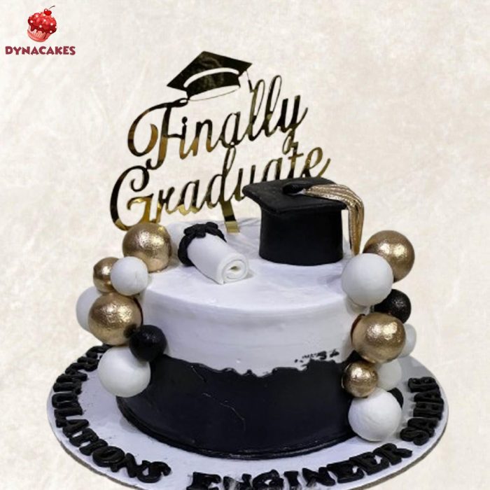 Graduate theme cream cake in Karachi decorated with graduation cap and diploma.