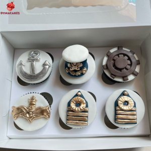 Navy-themed cupcakes decorated with edible anchors and Pakistan Navy logos in blue and white by Dyna Cakes Karachi