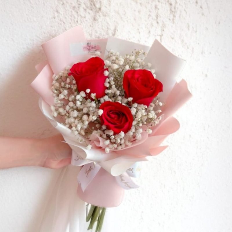 Romantic red rose bouquet with baby’s breath – hand-arranged and available for same-day delivery in Karachi.
