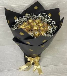 Ferry Rose chocolate bouquet wrapped with baby’s breath flowers in pastel paper and ribbon.