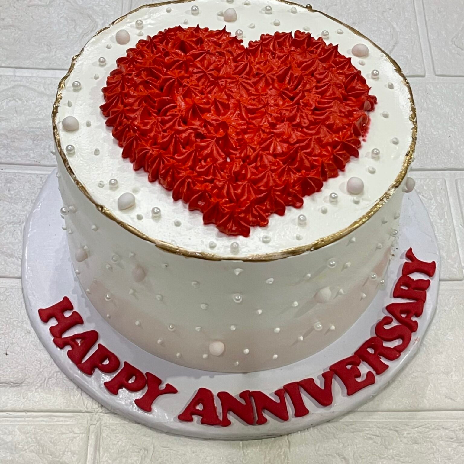 White Anniversary Cake with Red Heart