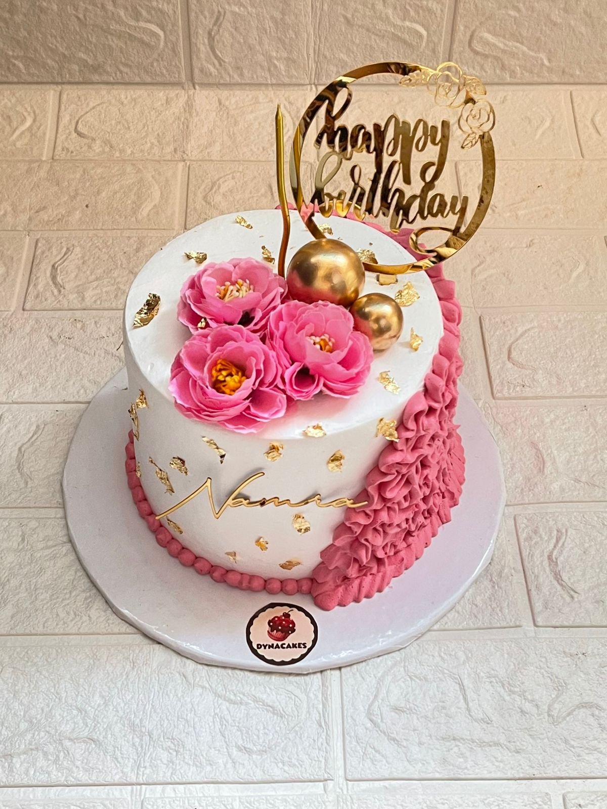 Pink Floral and White Birthday Cake with Gold Accents in Karachi